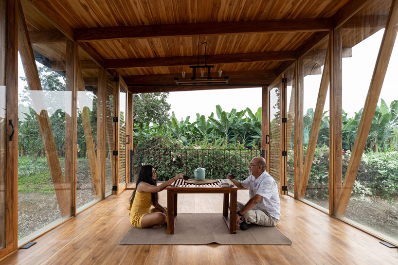 natura futura raises a timber tea room over a water channel in ecuador