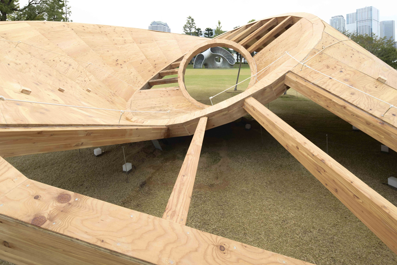 three interlocking timber rings shape TAILAND's playground pavilion in tokyo park