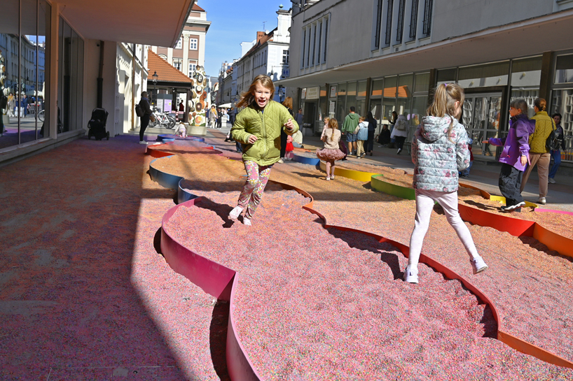 tons of colored aggregates mix together to form color path public art installation in poland
