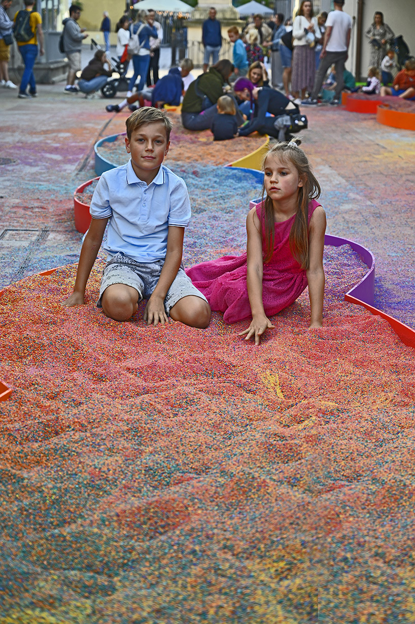 tons of colored aggregates mix together to form color path public art installation in poland