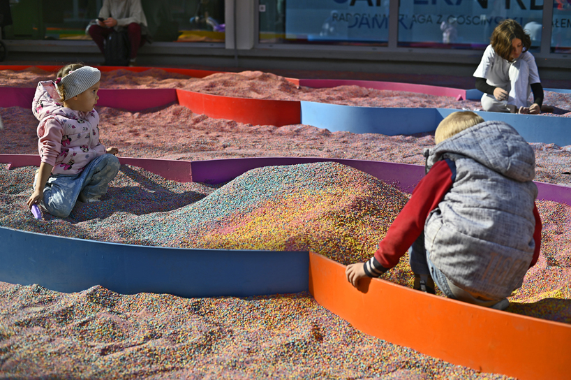 tons of colored aggregates mix together to form color path public art installation in poland