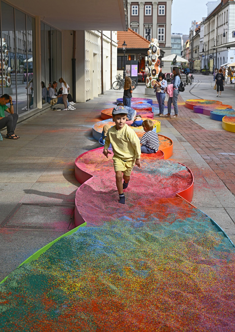 tons of colored aggregates mix together to form color path public art installation in poland
