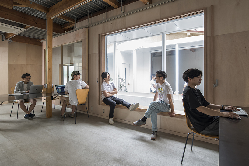 kosaku matsumoto reworks compact tokyo office interior with sliding doors and huge mirror