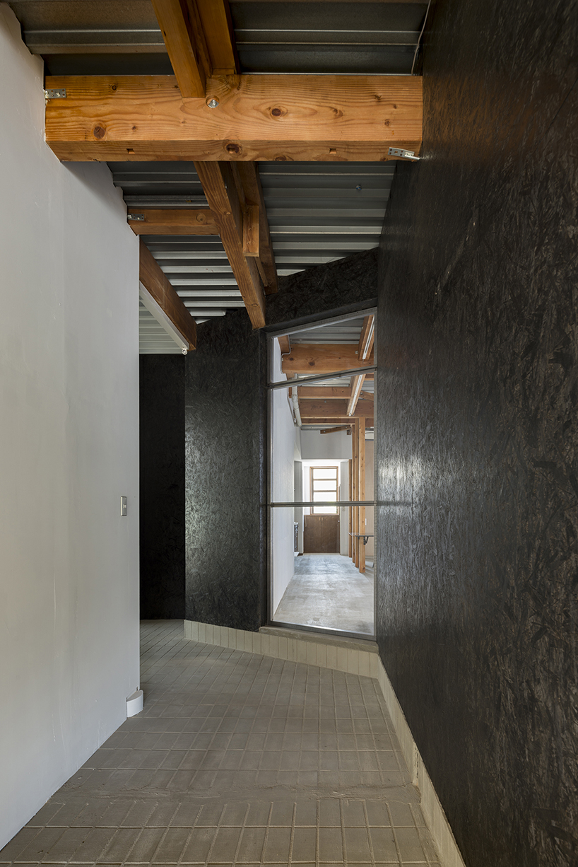 kosaku matsumoto reworks compact tokyo office interior with sliding doors and huge mirror