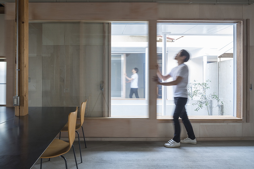 kosaku matsumoto reworks compact tokyo office interior with sliding doors and huge mirror