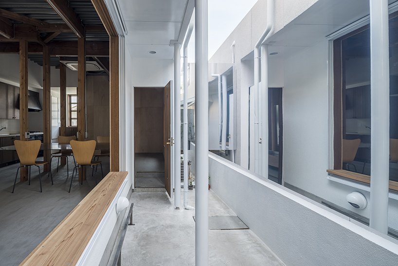 kosaku matsumoto reworks compact tokyo office interior with sliding doors and huge mirror