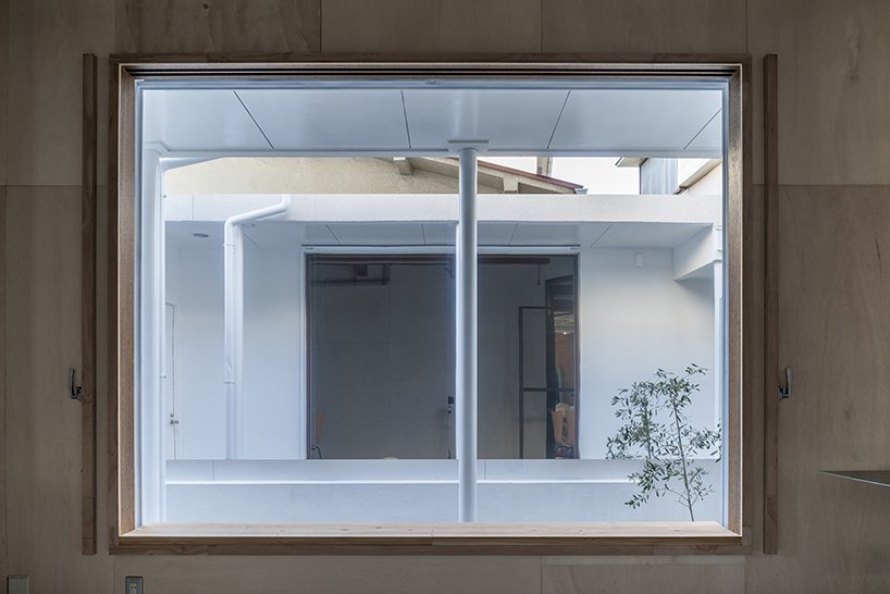 kosaku matsumoto reworks compact tokyo office interior with sliding doors and huge mirror