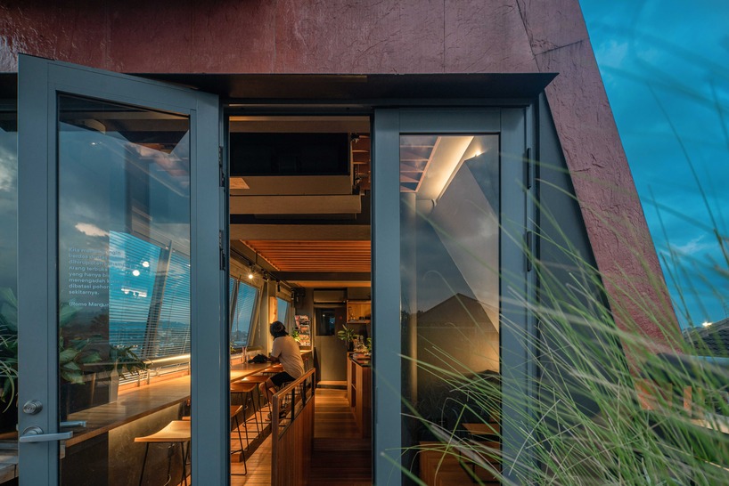 red agra sandstone coats the facades of slender PituRooms hotel in indonesia