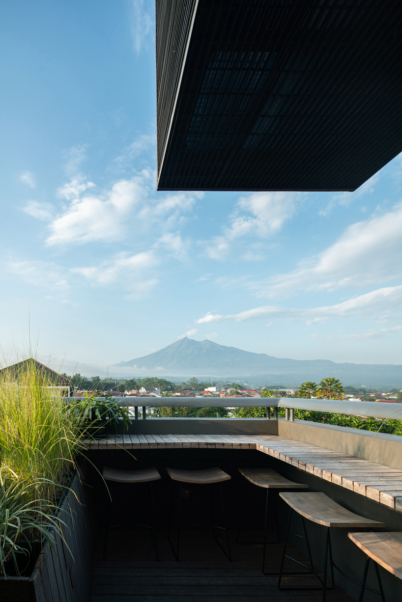 red agra sandstone coats the facades of slender PituRooms hotel in indonesia