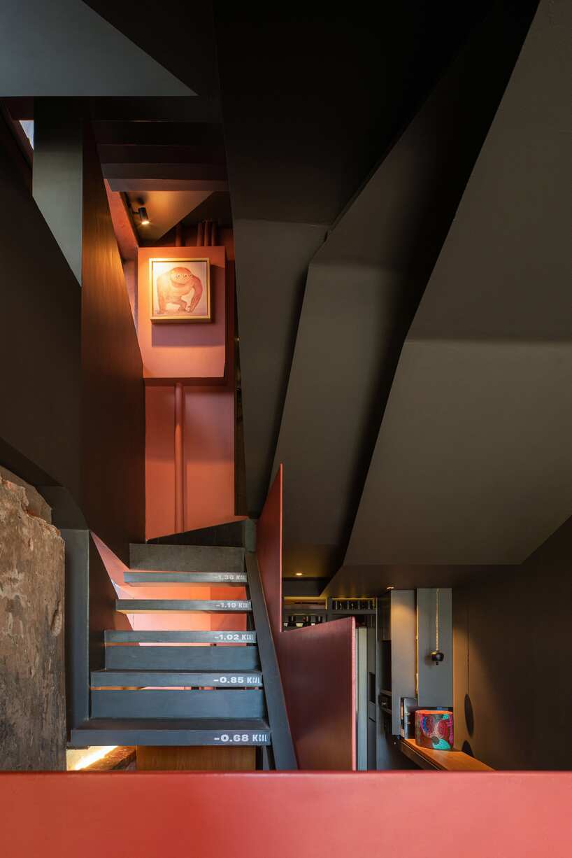 red agra sandstone coats the facades of slender PituRooms hotel in indonesia