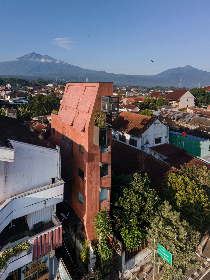 red agra sandstone coats the facades of slender PituRooms hotel in indonesia