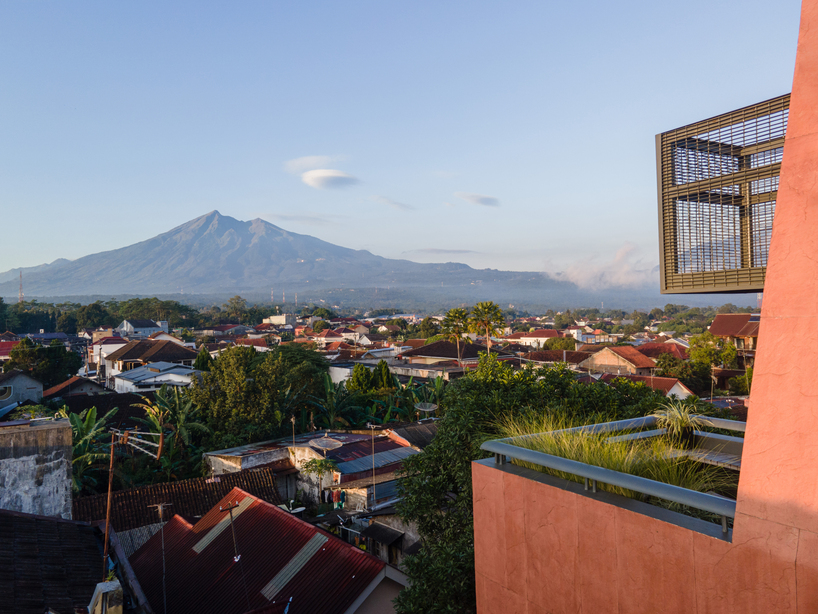 red agra sandstone coats the facades of slender PituRooms hotel in indonesia