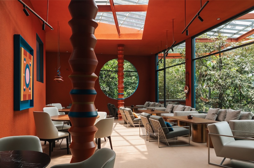 azure blue hues contrast with terracotta tiles on nusa kitchen pavilion's facade in java