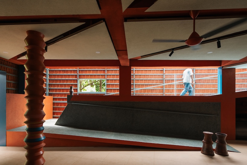 azure blue hues contrast with terracotta tiles on nusa kitchen pavilion's facade in java