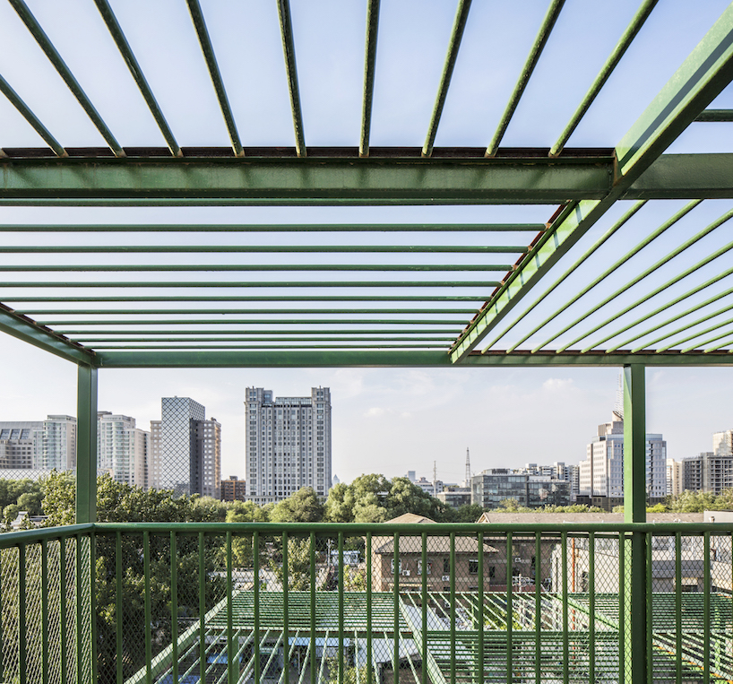 MAT office's courtyard in beijing is fenced by green steel canopy imitating trees