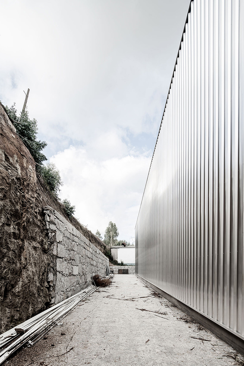 martins architecture office constructs large reflective warehouse in portugal