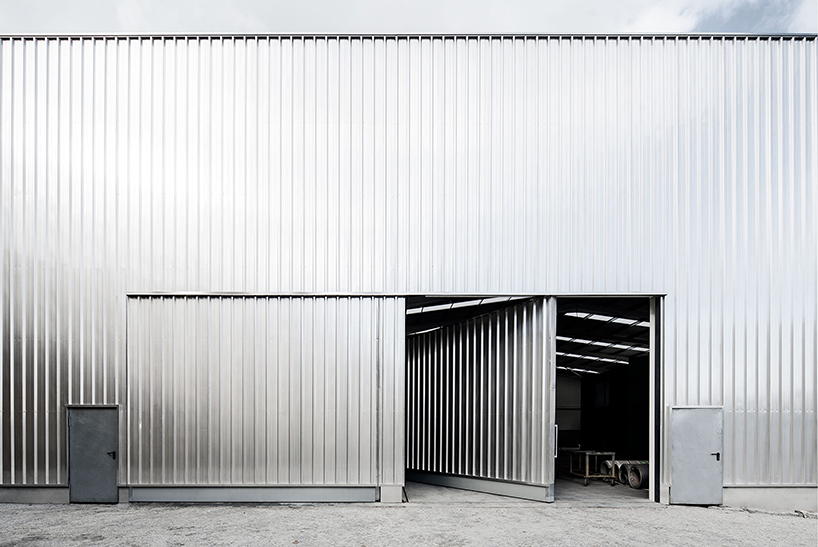 martins architecture office constructs large reflective warehouse in portugal