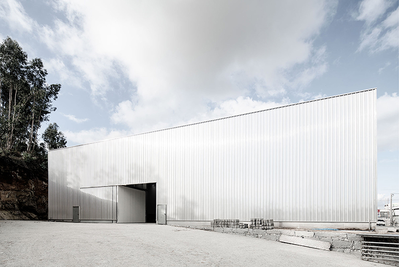 martins architecture office constructs large reflective warehouse in portugal