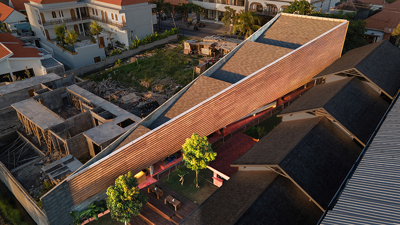restaurant by studio kota cascades down balinese terrain in a series of open-air platforms