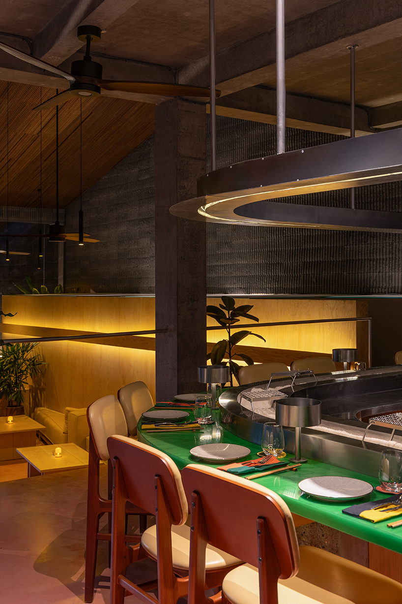 restaurant by studio kota cascades down balinese terrain in a series of open-air platforms