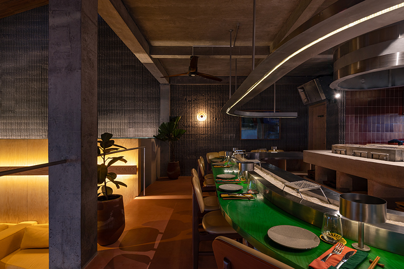 restaurant by studio kota cascades down balinese terrain in a series of open-air platforms