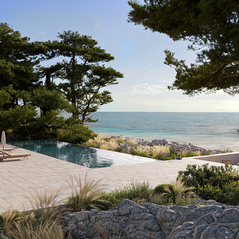 beach club’s stepped stone volumes and timber pergolas surround lagoon-like pool in greece - 6