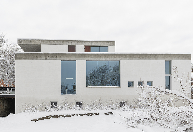 chado’s monolithic white concrete brick office stands near botanical garden in russia - 2