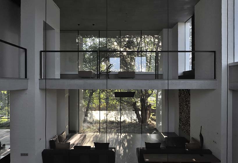 chado’s monolithic white concrete brick office stands near botanical garden in russia - 6