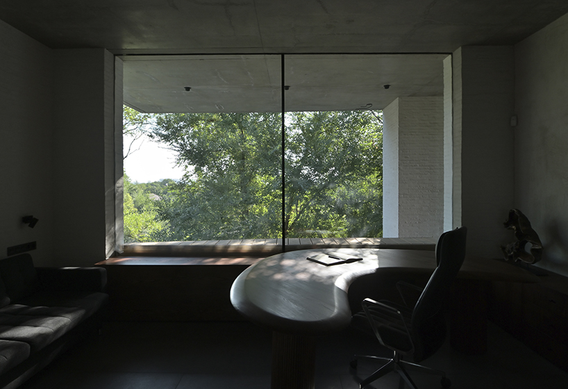 chado’s monolithic white concrete brick office stands near botanical garden in russia - 8