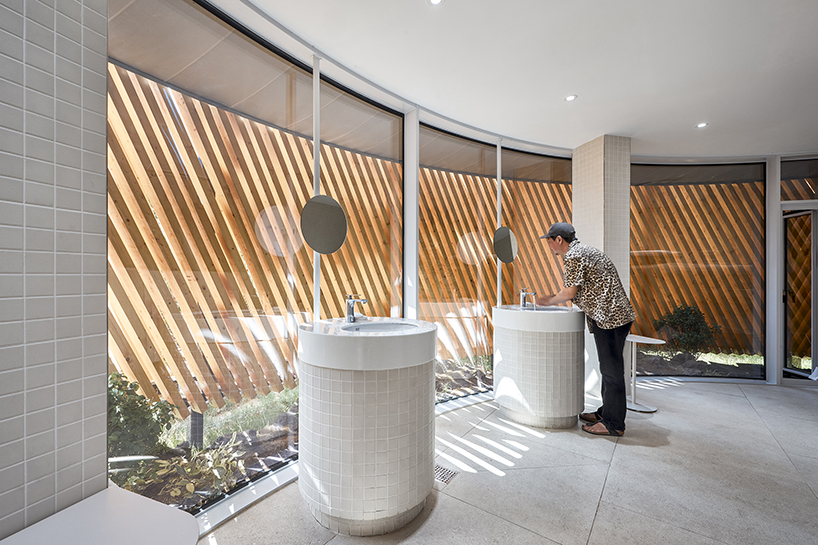 double-layer timber facade enfolds renovated public toilet in korea by daniel valle architects