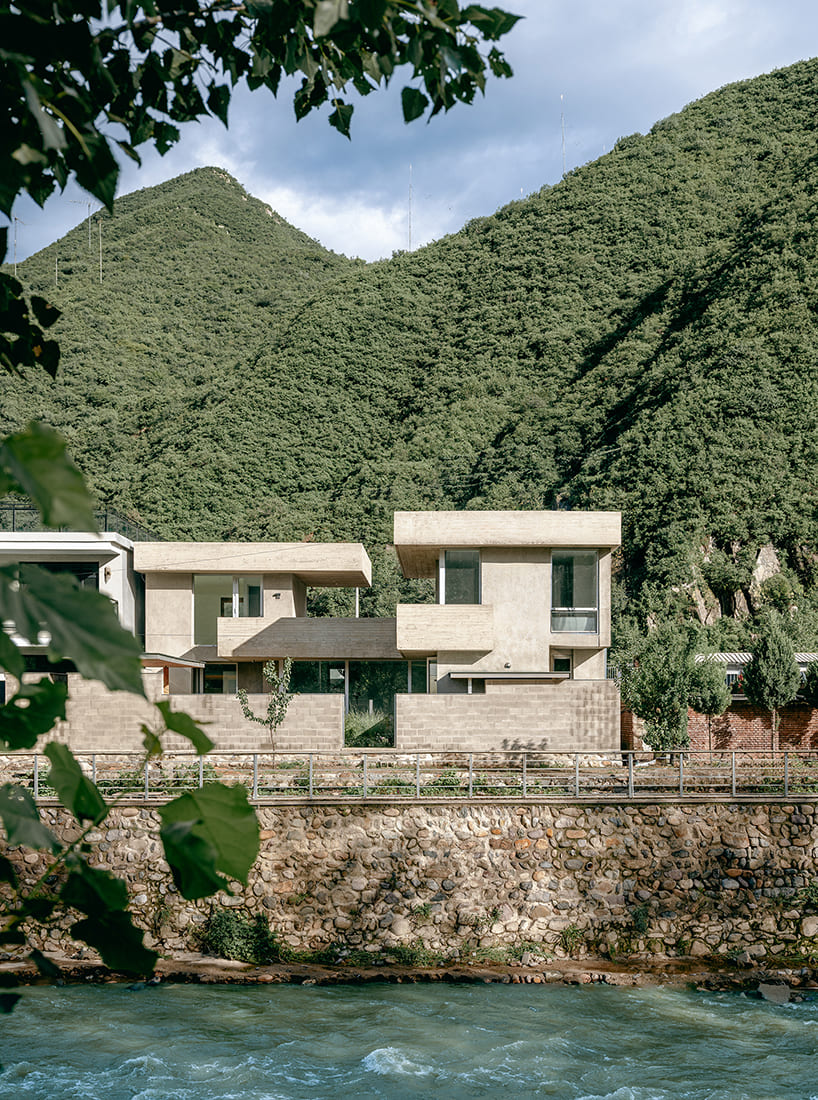 riverside house's geometric concrete volumes by xiān architects pop up in rural beijing
