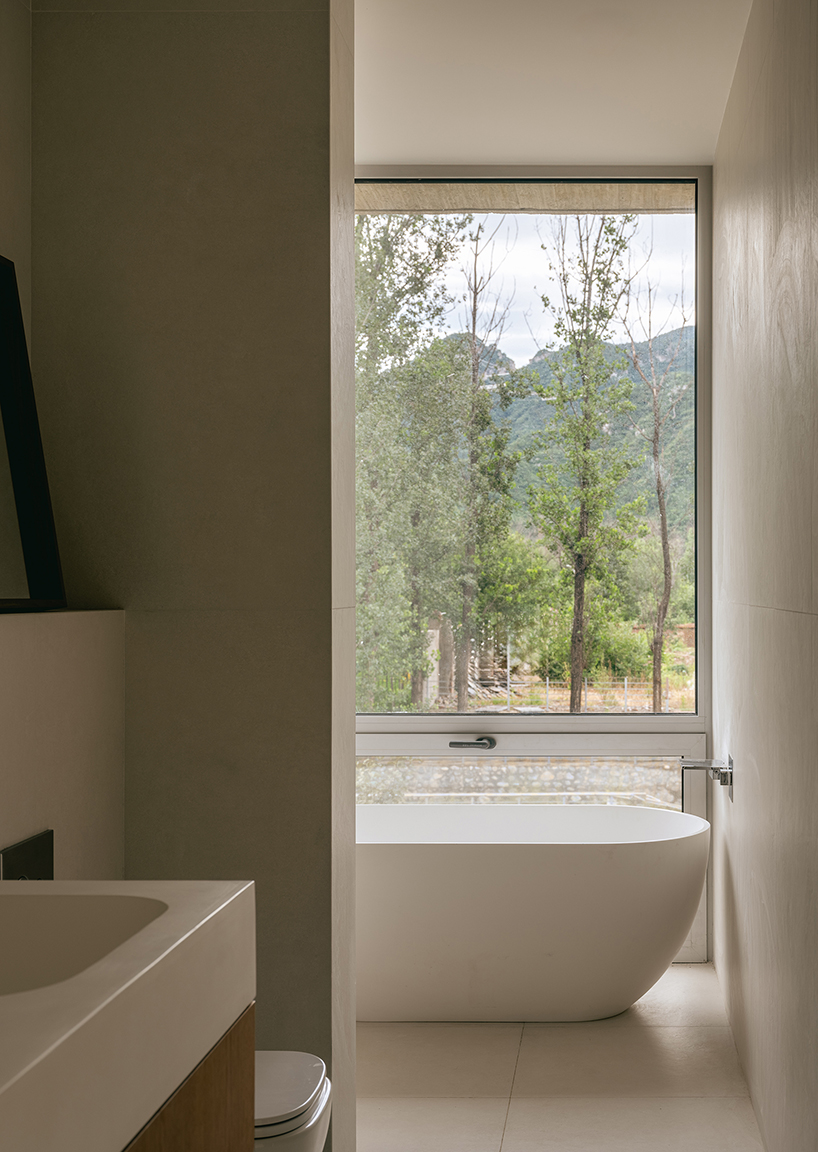 riverside house's geometric concrete volumes by xiān architects pop up in rural beijing