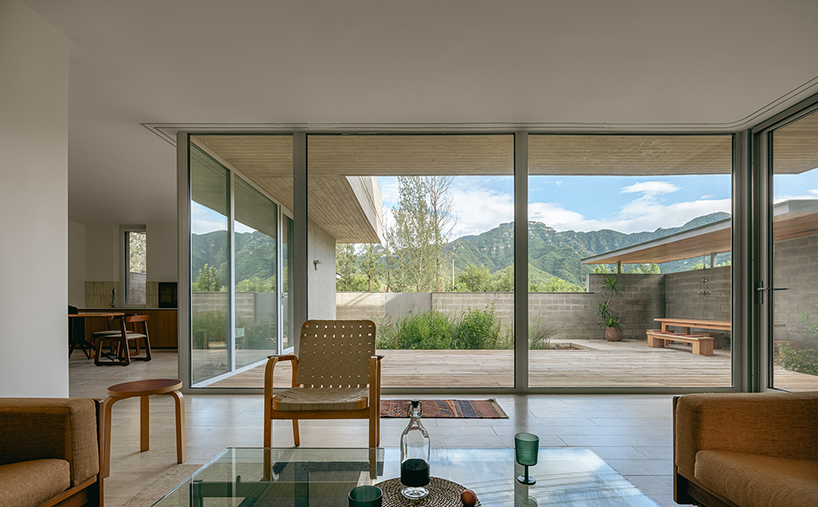 riverside house's geometric concrete volumes by xiān architects pop up in rural beijing