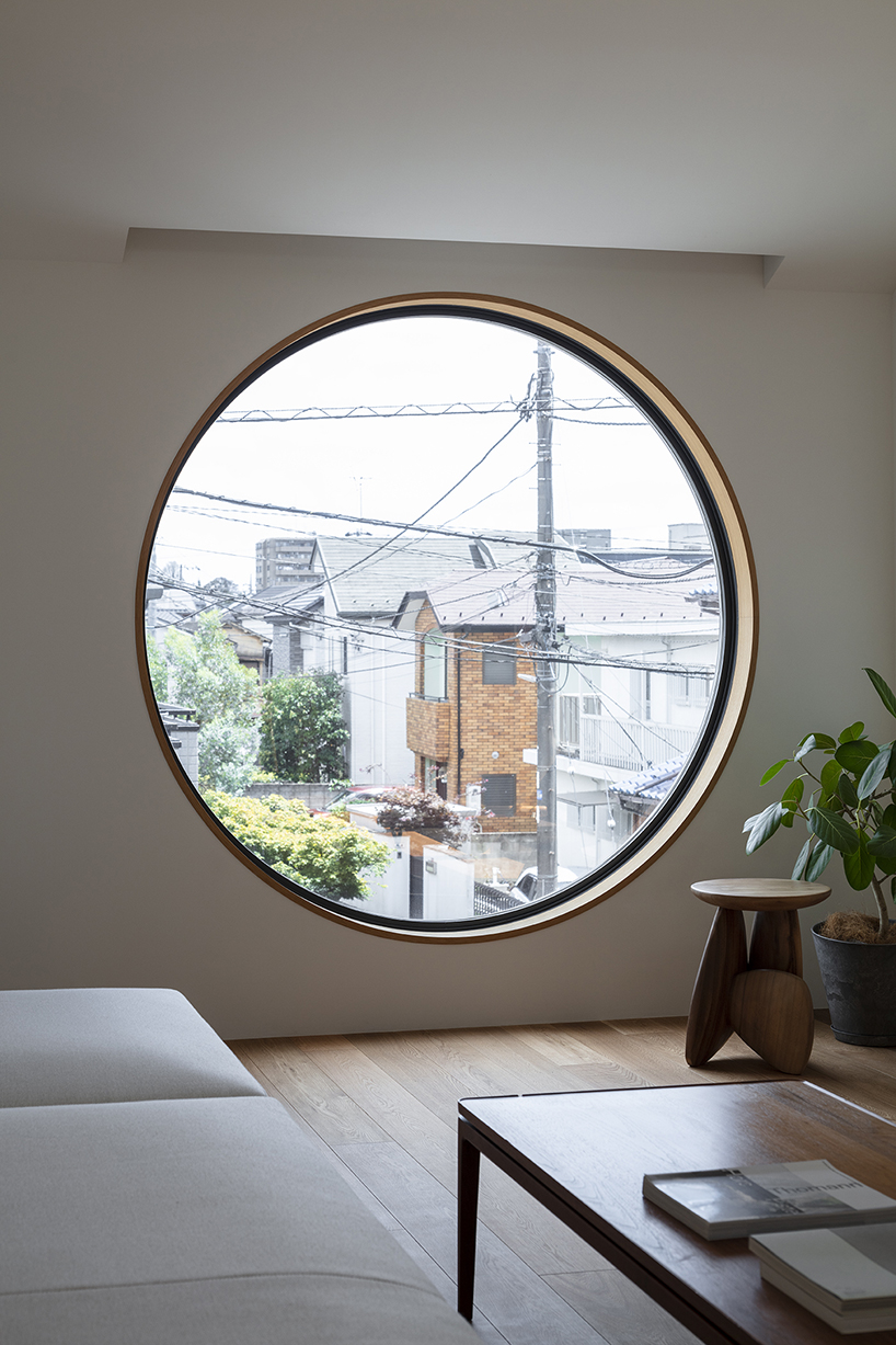 circular aperture welcomes natural light within gabled tokyo house by KIAS