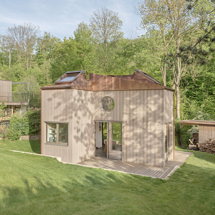 villa minimale in vienna comprises four identical wooden boxes in cross-plan configuration