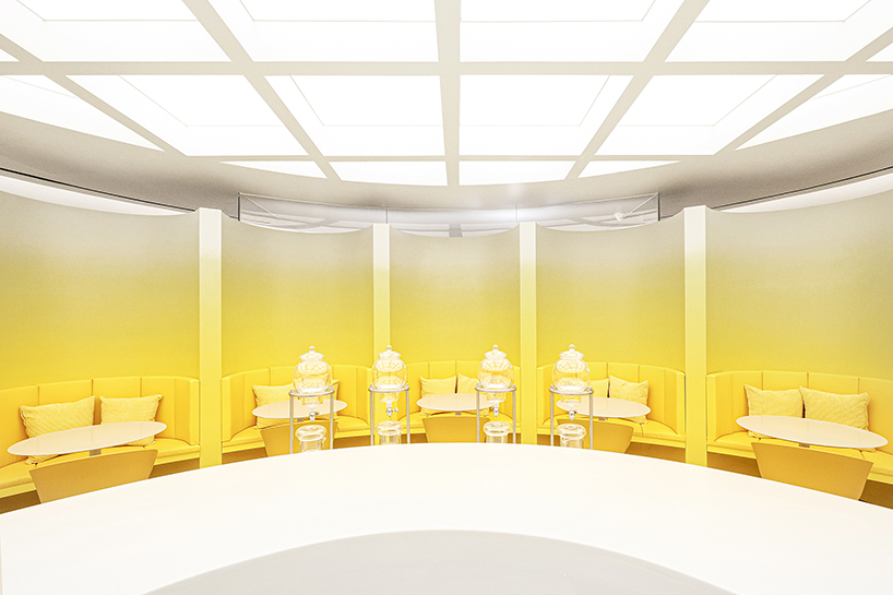 curved yellow walls define theatrical pastry shop interior by ramoprimo in beijing
