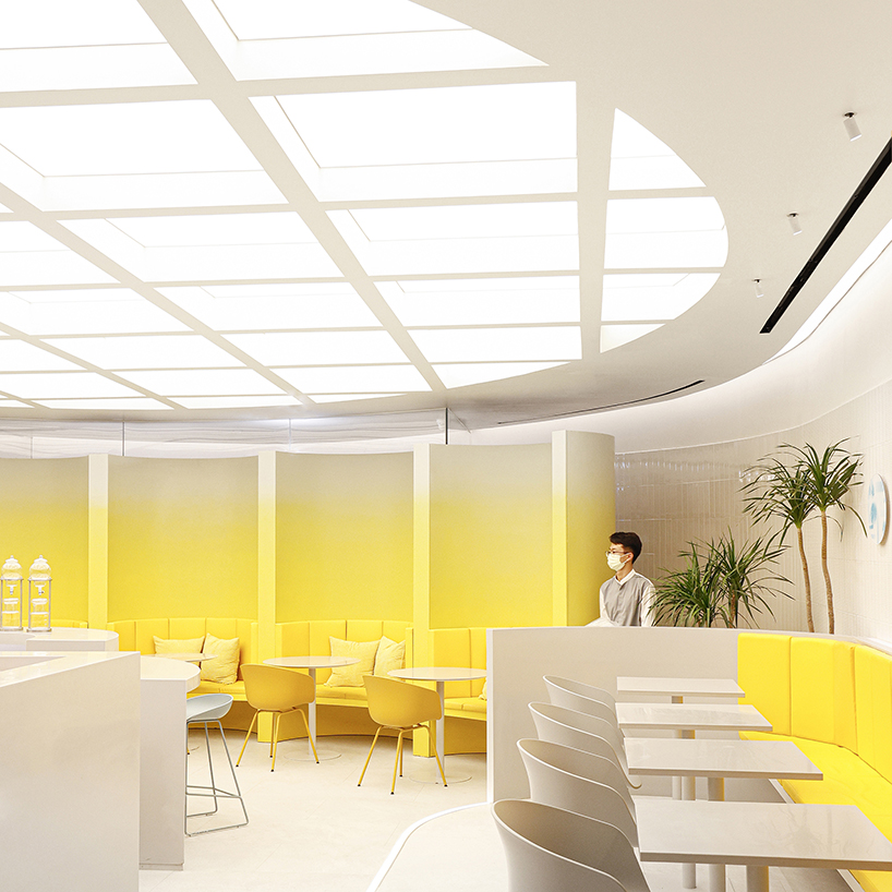 curved yellow walls define theatrical pastry shop interior by ramoprimo in beijing