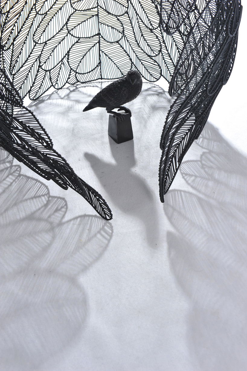 apiwat chitapanya welds stainless steel feathers to create table collection