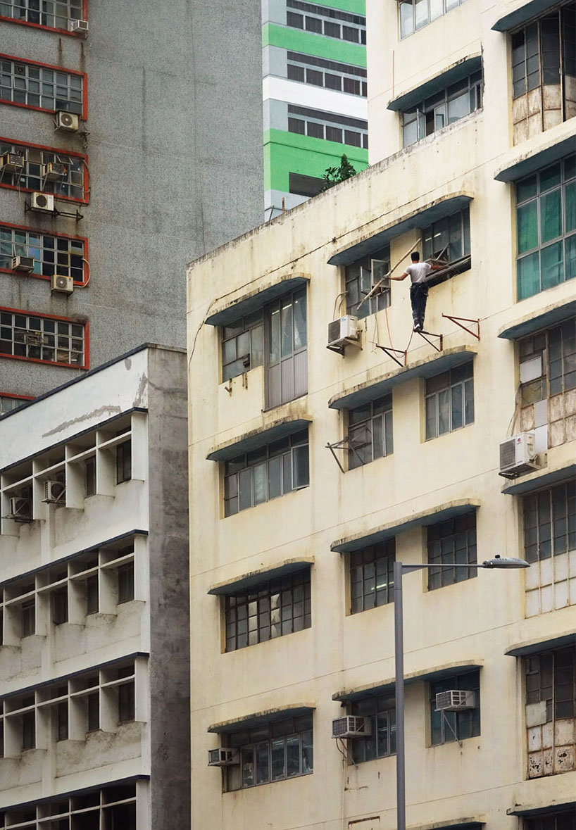 romain jacquet-lagrèze captures bamboo scaffolding workers hovering above hong kong