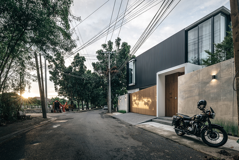 anonym studio combines wood, concrete and metal in a family residence in bangkok