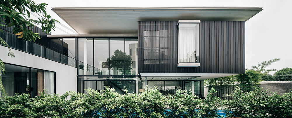 anonym studio combines wood, concrete and metal in a family residence in bangkok