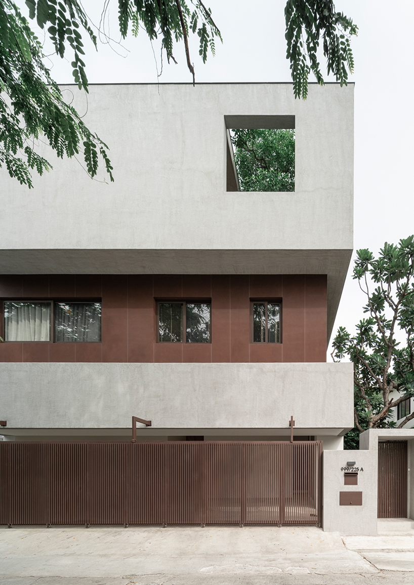 anonym studio stacks geometric rust and mortar volumes in tropical bangkok house