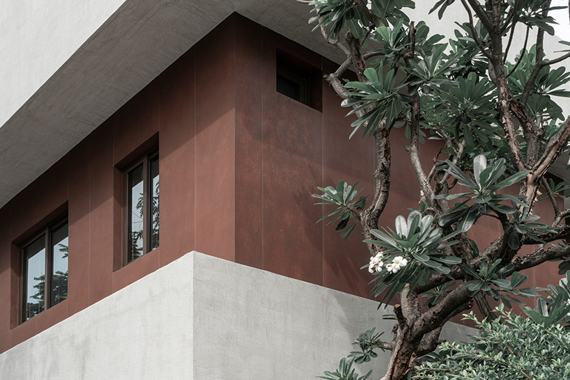 anonym studio stacks geometric rust and mortar volumes in tropical bangkok house