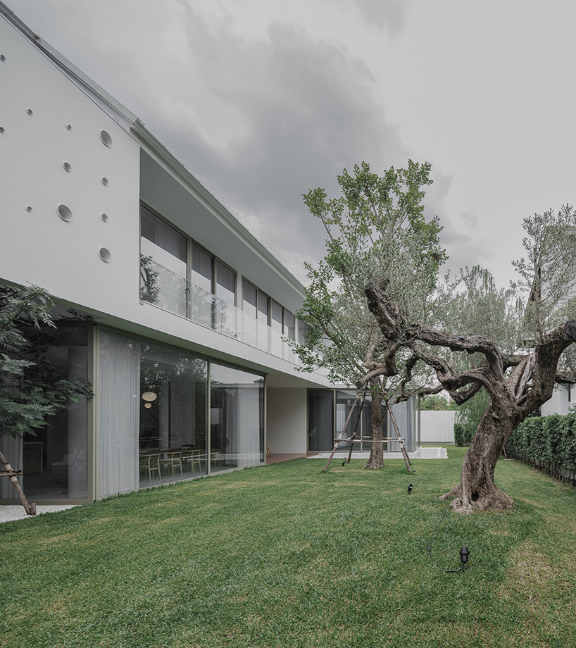 anonym studio's all-white house in bangkok adopts scandinavian minimalism