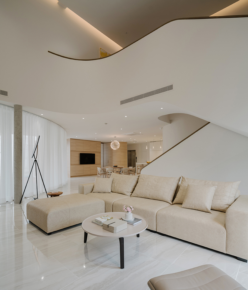 curved concrete volumes interlock through glass hinge to extend oom house in bangkok - 9