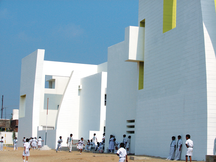 NUDES builds high school as monolithic mass 'punctuated' by voids in india