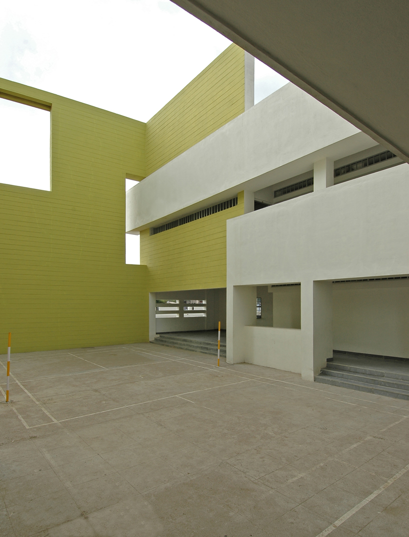 NUDES builds high school as monolithic mass 'punctuated' by voids in india