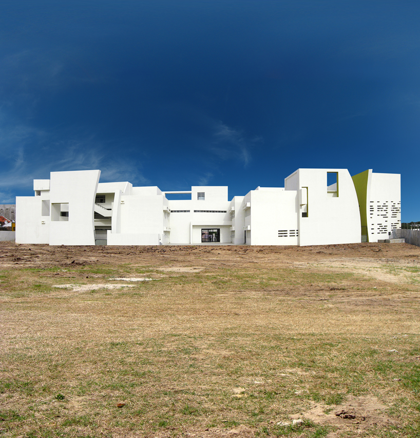 NUDES builds high school as monolithic mass 'punctuated' by voids in india