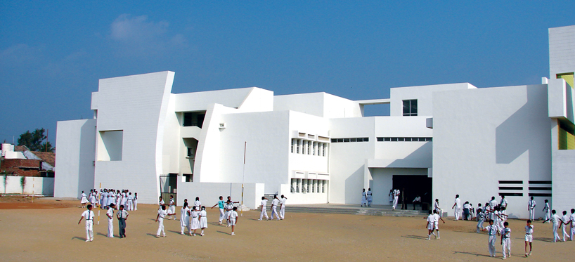 NUDES builds high school as monolithic mass 'punctuated' by voids in india