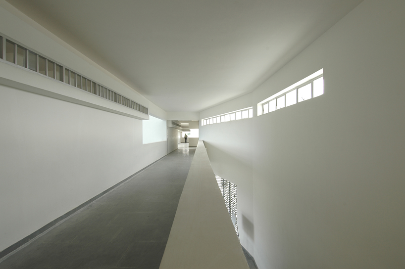 NUDES builds high school as monolithic mass 'punctuated' by voids in india